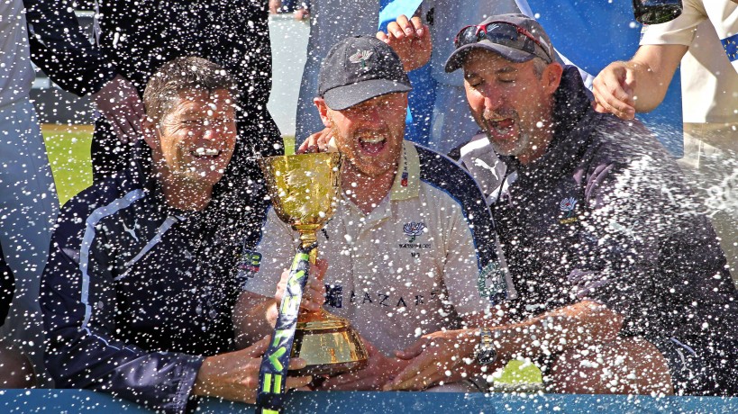 LONDON, ENGLAND - SEPTEMBER 12: Yorkshire Director of Professional Cricket Martyn Moxen, Club captain Andrew Gale and First Team Coach Jason Gillespie with the County Championship Trophy as champagne is sprayed over them by Ryan Sidebottom after the LV County Championship match between Middlesex and Yorkshire at Lord's Cricket Ground on September 12, 2015 in London, England. (Photo by Sarah Ansell/Getty Images)